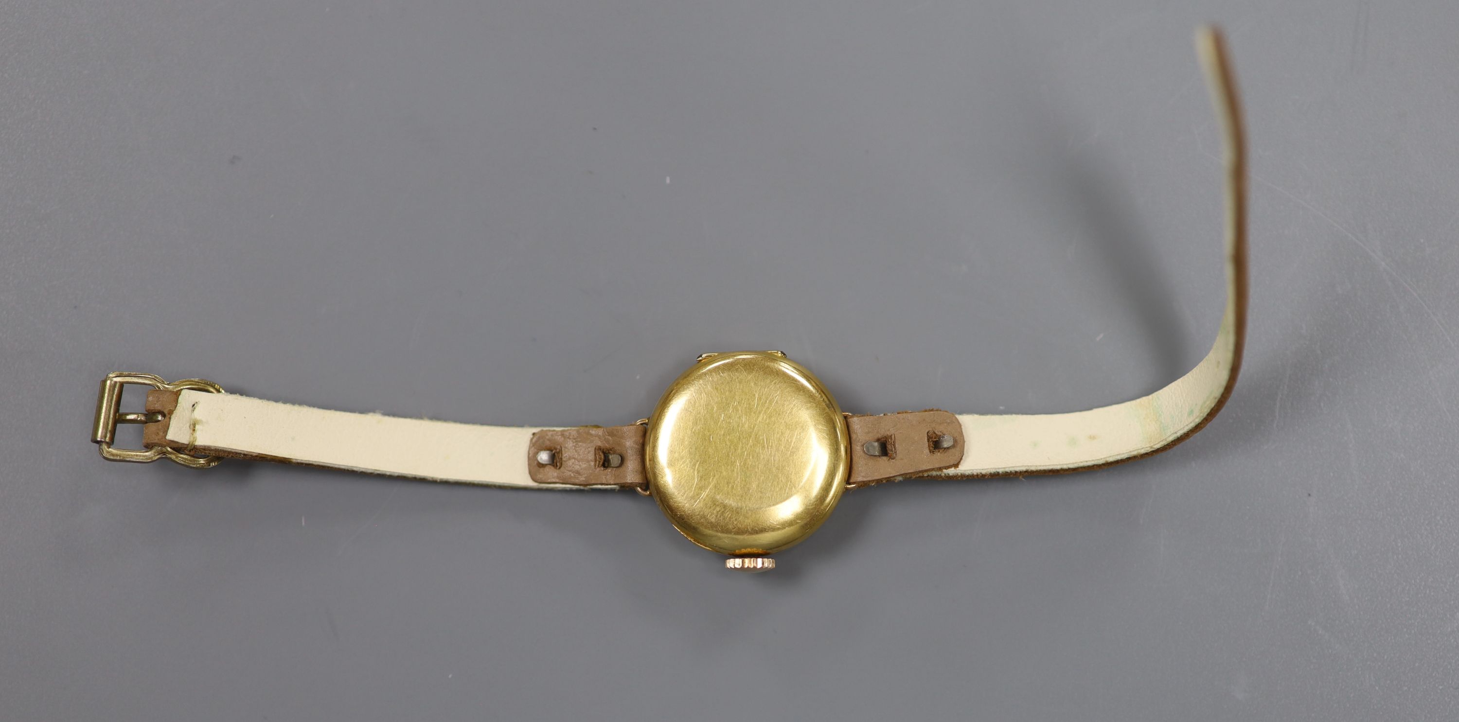 A lady's early to mid 20th century 18k yellow metal and diamond set manual wind wrist watch, on a leather strap